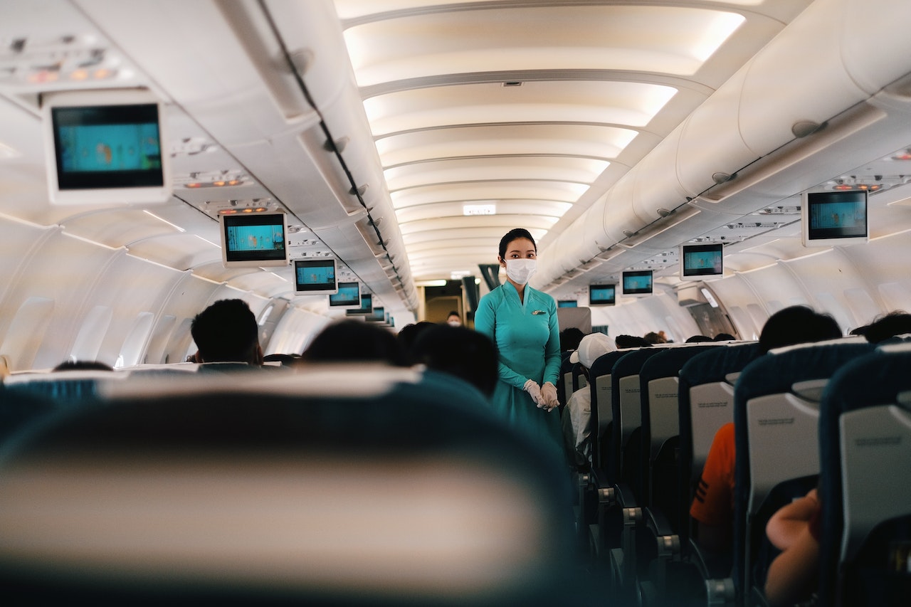 A flight attendant standing in the cabin