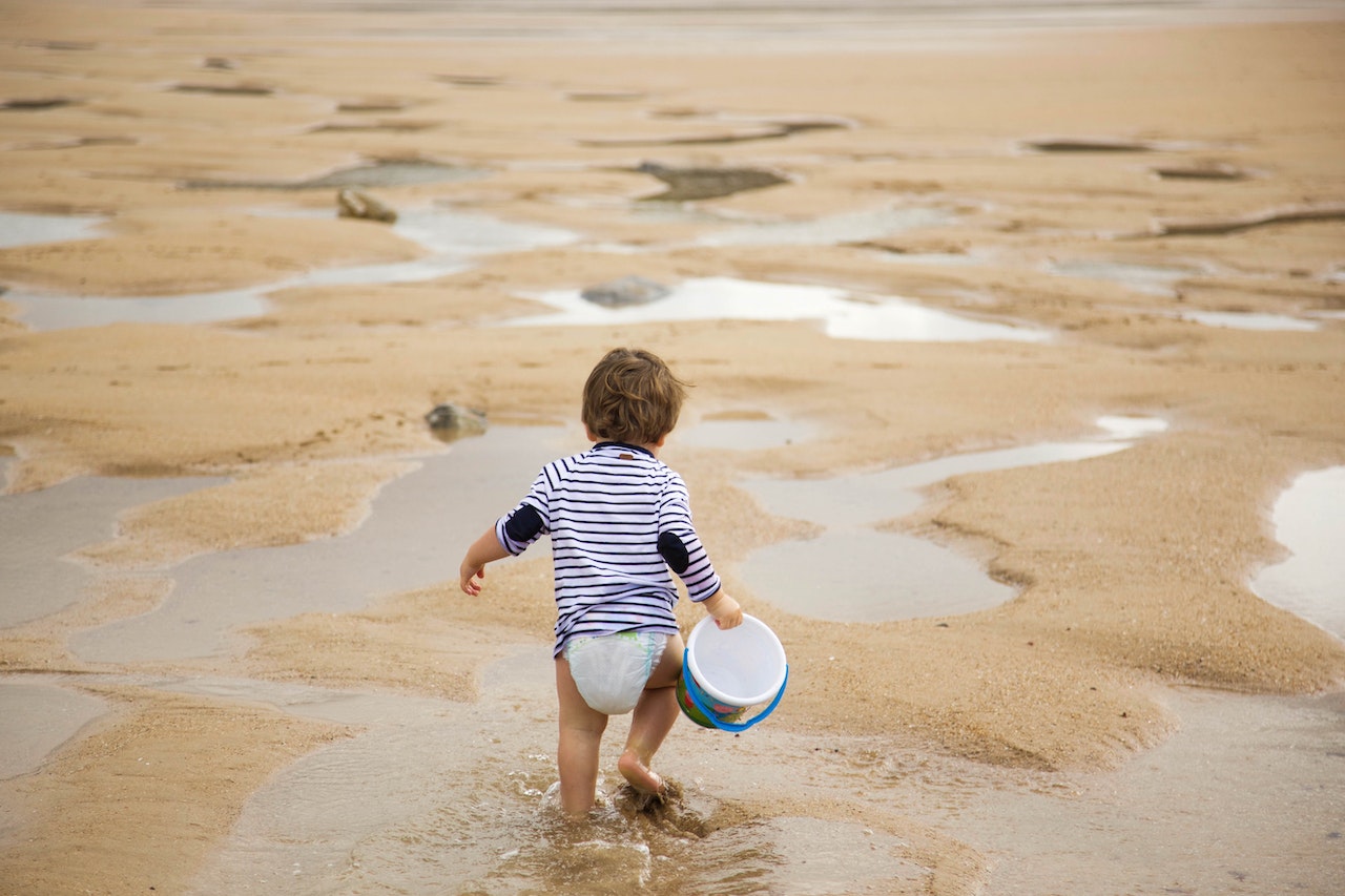 Kid walking on shoreline
